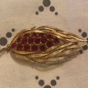 Vintage gold tone leaf pin with red stones